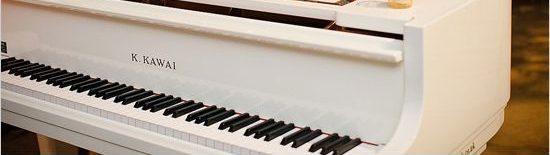 White Piano with Candles and Flower on top